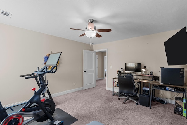 carpeted office space with ceiling fan