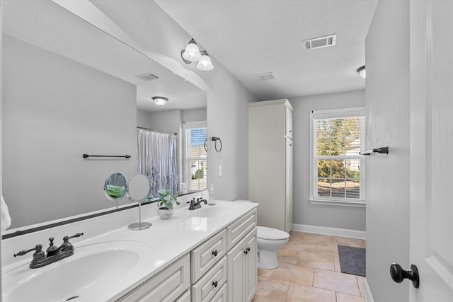 bathroom with vanity, a shower with shower curtain, and toilet