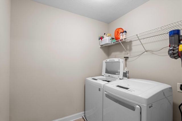 washroom featuring washer and clothes dryer