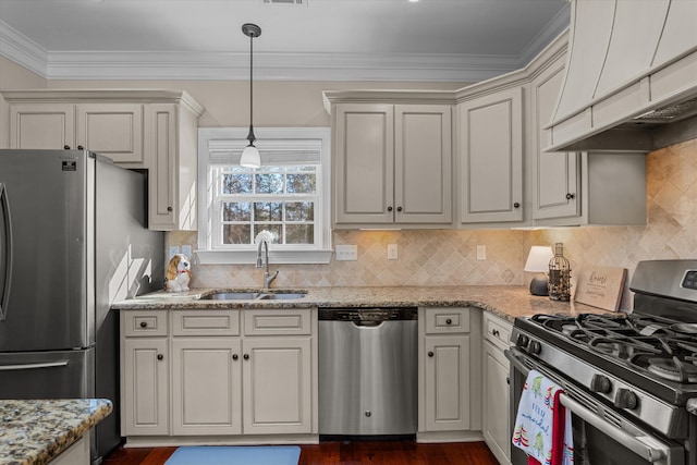 kitchen featuring light stone countertops, appliances with stainless steel finishes, sink, and premium range hood