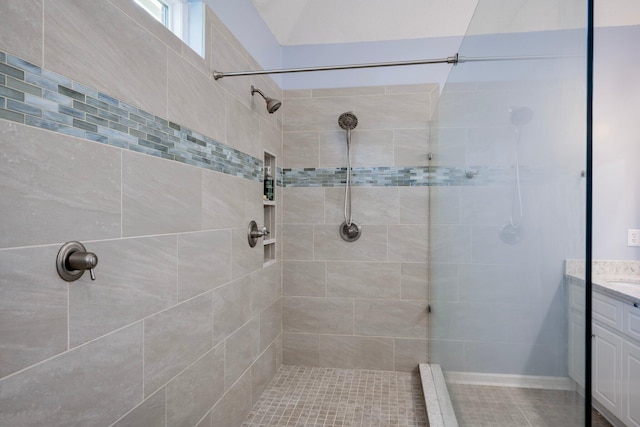 bathroom featuring vanity and a tile shower
