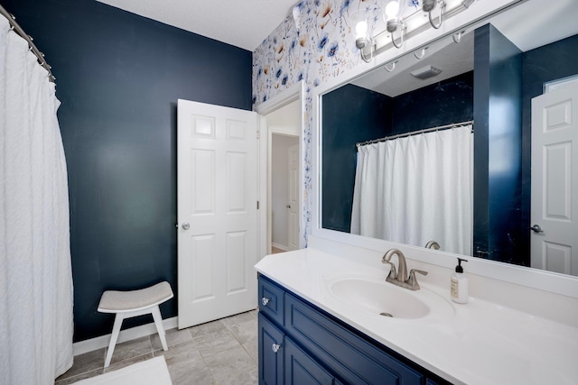 bathroom with baseboards, vanity, and a shower with curtain