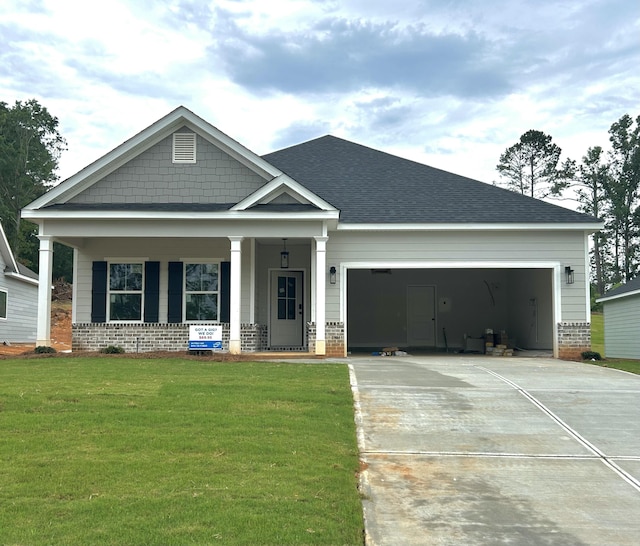 140 Tanager Ln, Evans, GA 30809 - craftsman-style home with brick siding, concrete driveway, a porch, and a garage