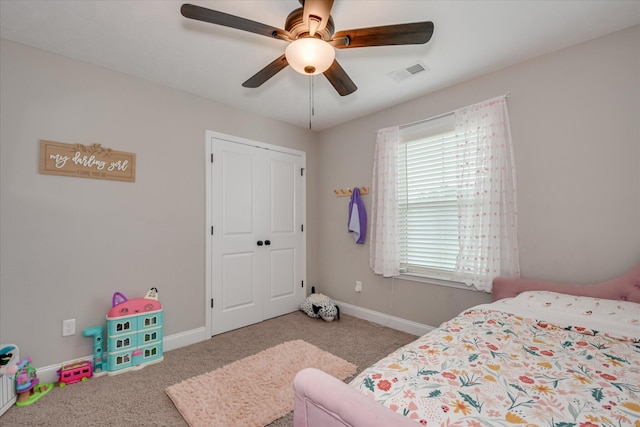 carpeted bedroom with a ceiling fan, baseboards, visible vents, and a closet
