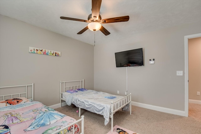 carpeted bedroom featuring baseboards and ceiling fan