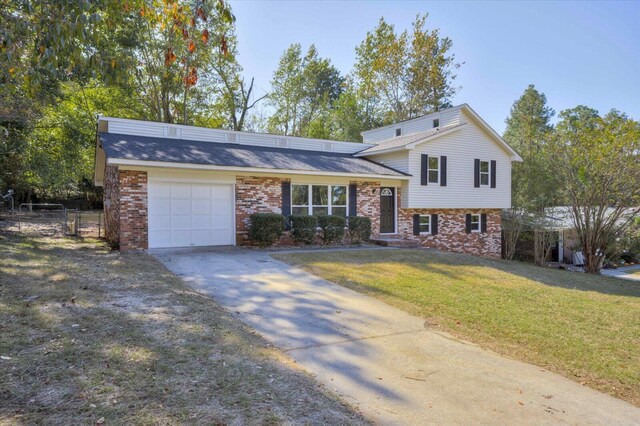 split level home featuring a front yard and a garage