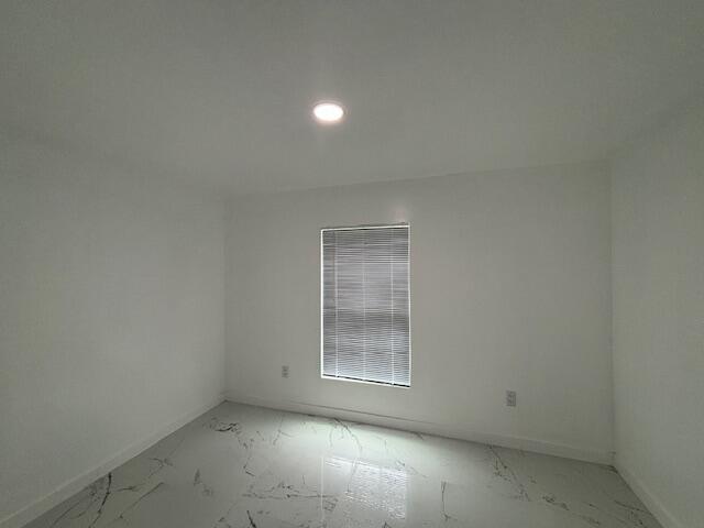 875 Earle St, Thomson, GA 30824 - empty room featuring marble look tiles, recessed lighting, and baseboards