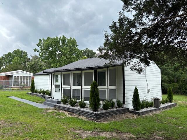 875 Earle St, Thomson, GA 30824 - back of property with a yard and central AC