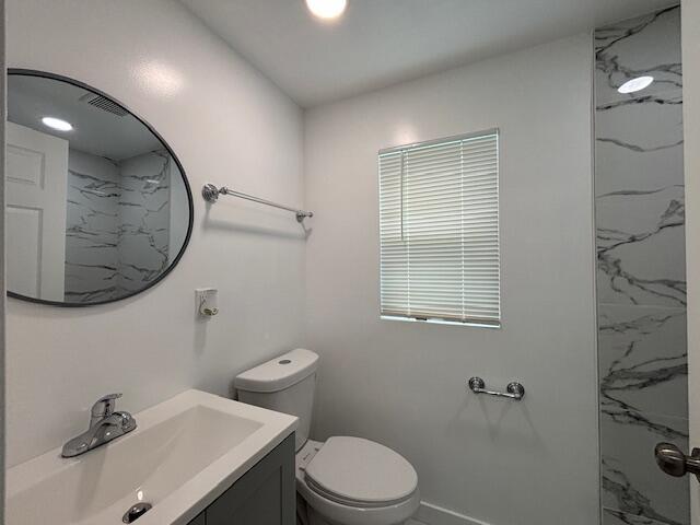 875 Earle St, Thomson, GA 30824 - bathroom with vanity, toilet, and a marble finish shower