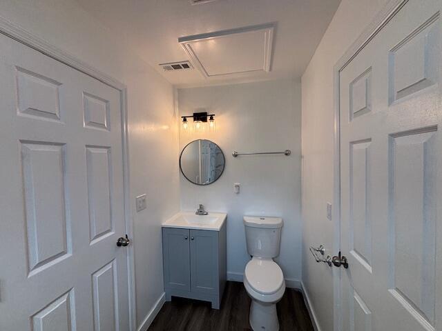 875 Earle St, Thomson, GA 30824 - bathroom with wood finished floors, vanity, baseboards, and toilet