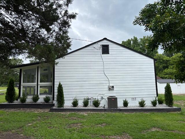 875 Earle St, Thomson, GA 30824 - view of side of home with a yard and central AC unit