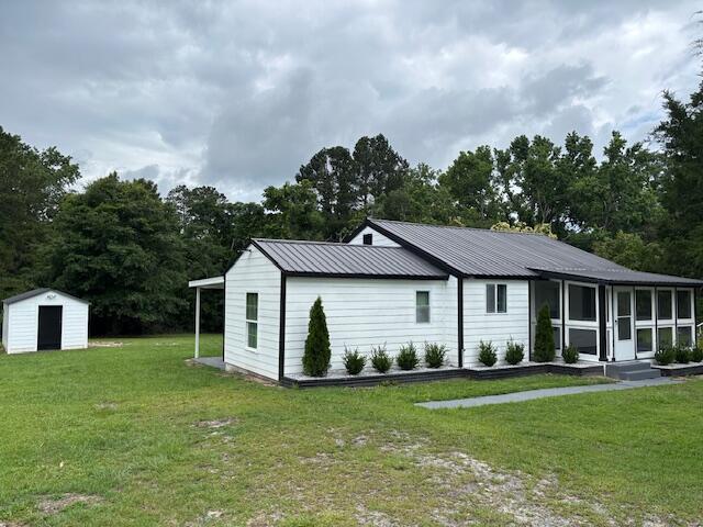 875 Earle St, Thomson, GA 30824 - view of front facade featuring a front lawn and metal roof
