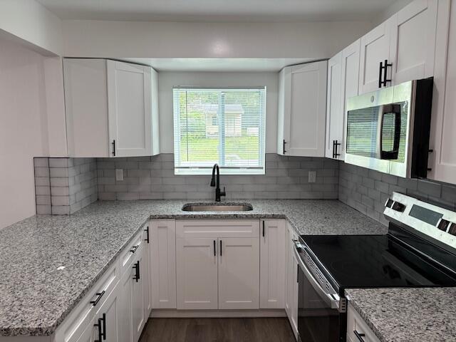 875 Earle St, Thomson, GA 30824 - kitchen with appliances with stainless steel finishes, a sink, and white cabinetry