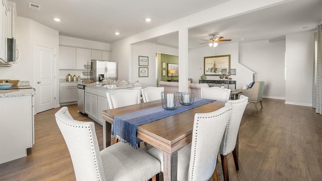 dining room featuring recessed lighting, wood finished floors, a ceiling fan, baseboards, and visible vents