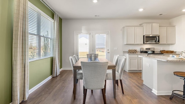 dining room featuring baseboards, visible vents, dark wood finished floors, and recessed lighting