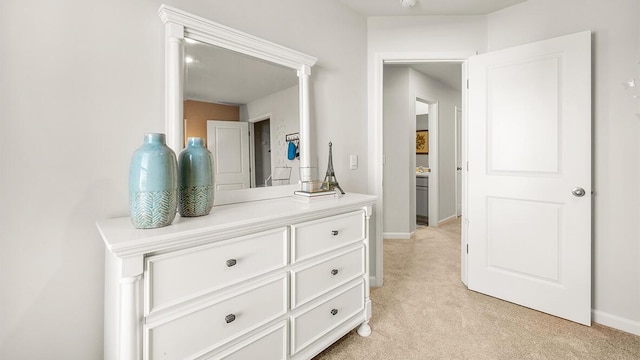 interior space with baseboards and light colored carpet