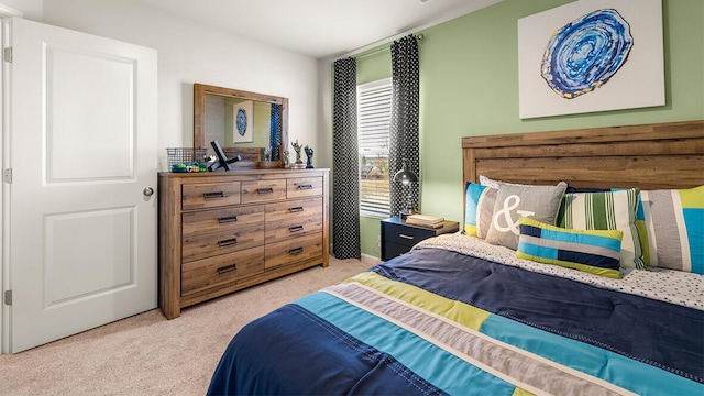 bedroom featuring light colored carpet