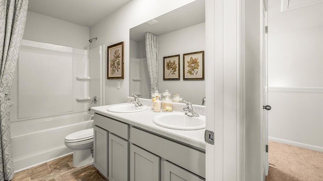 bathroom with shower / tub combo, a sink, toilet, and double vanity