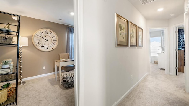 hall with recessed lighting, light colored carpet, visible vents, and baseboards