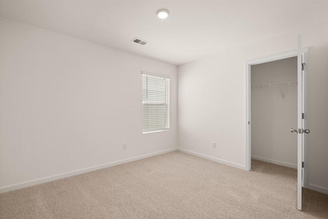 unfurnished bedroom with light colored carpet, visible vents, and baseboards