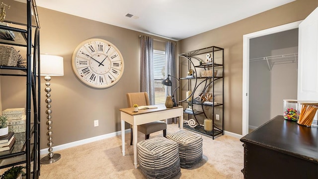 office space featuring light carpet, baseboards, and visible vents