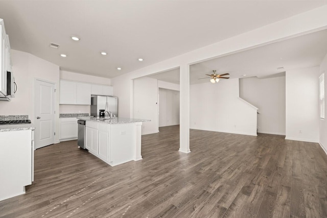 kitchen with stainless steel appliances, dark wood-type flooring, open floor plan, a kitchen island with sink, and white cabinets