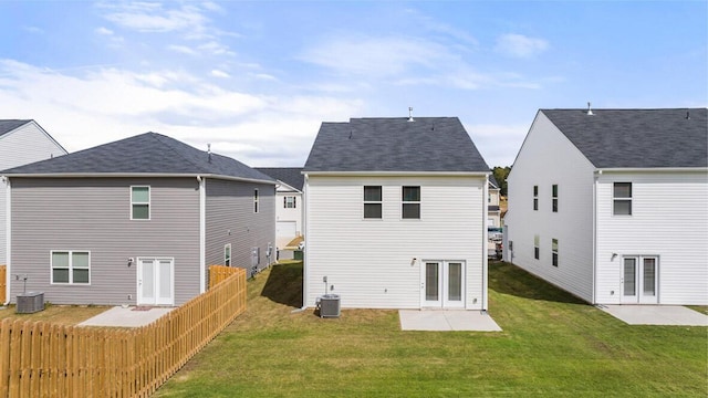 back of house featuring a patio, central AC, fence, a yard, and french doors