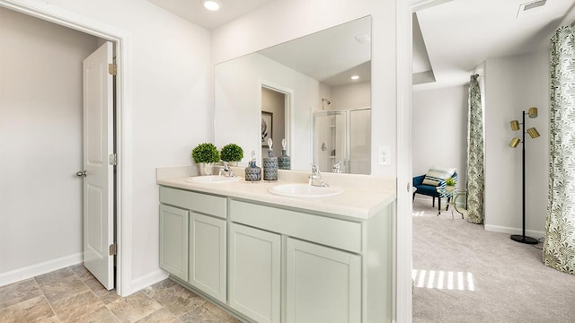 bathroom with double vanity, visible vents, an enclosed shower, and a sink