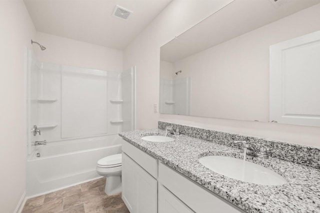 bathroom featuring toilet, shower / tub combination, a sink, and visible vents