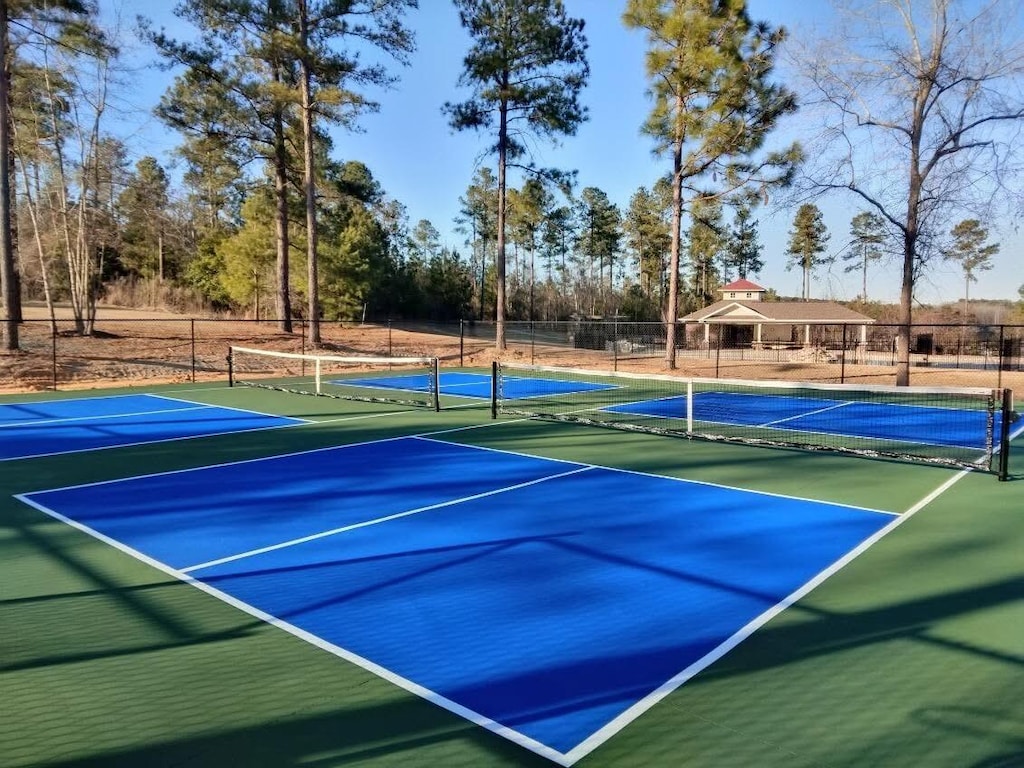 view of tennis court featuring fence