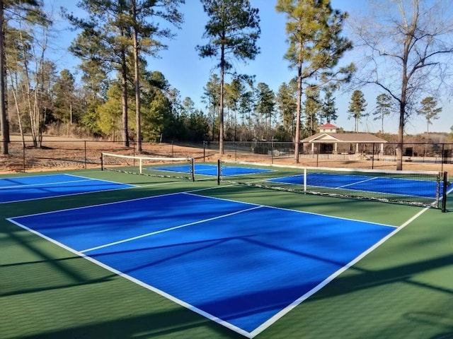 view of tennis court featuring fence