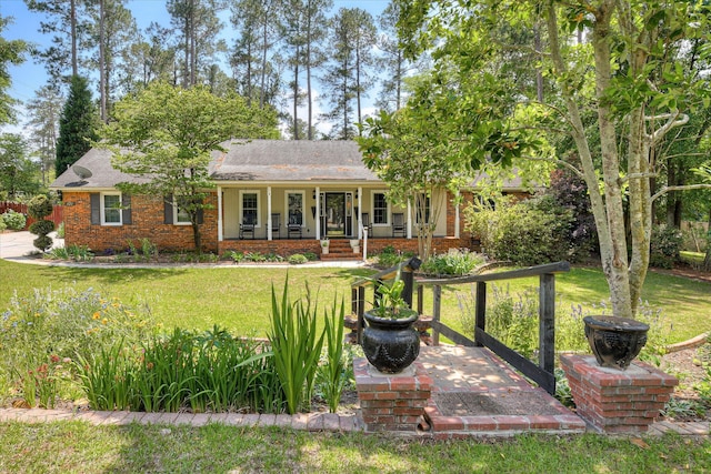 101 Hartwell Dr, Aiken, SC 29803 - view of front facade with covered porch, a front yard, brick siding, and roof with shingles