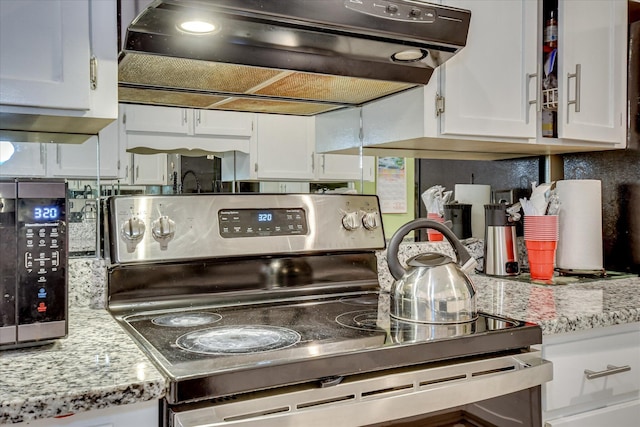 101 Hartwell Dr, Aiken, SC 29803 - kitchen with stainless steel appliances, extractor fan, white cabinetry, and light stone countertops