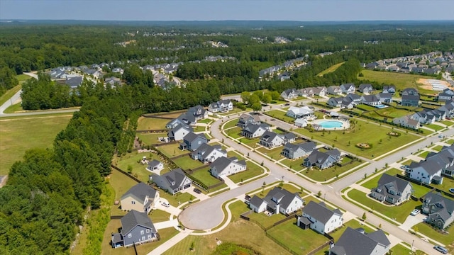 drone / aerial view with a residential view and a view of trees