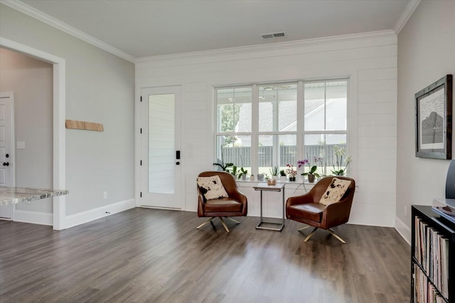 sitting room featuring baseboards, visible vents, dark wood finished floors, and ornamental molding