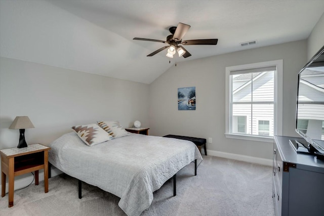 bedroom with lofted ceiling, visible vents, light carpet, ceiling fan, and baseboards