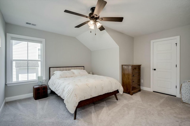 bedroom with baseboards, visible vents, a ceiling fan, and light colored carpet