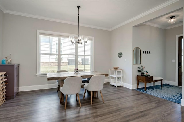 dining space featuring baseboards, ornamental molding, dark wood finished floors, and a notable chandelier