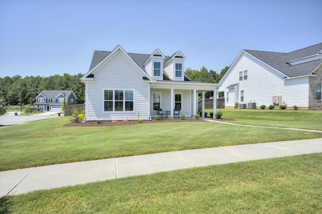 view of front of property with covered porch, a front yard, and central air condition unit