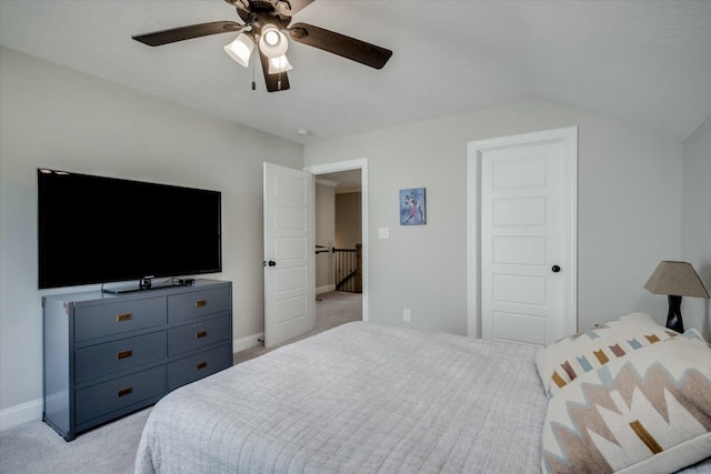 bedroom with light carpet, ceiling fan, baseboards, and lofted ceiling