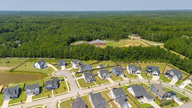 bird's eye view with a water view, a wooded view, and a residential view