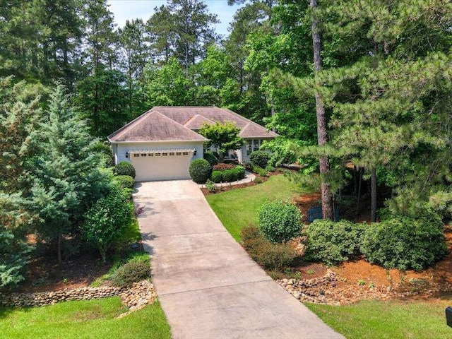 view of front of property with a front lawn and a garage