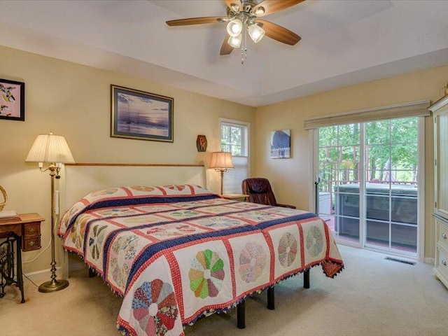 bedroom featuring access to exterior, light colored carpet, and ceiling fan