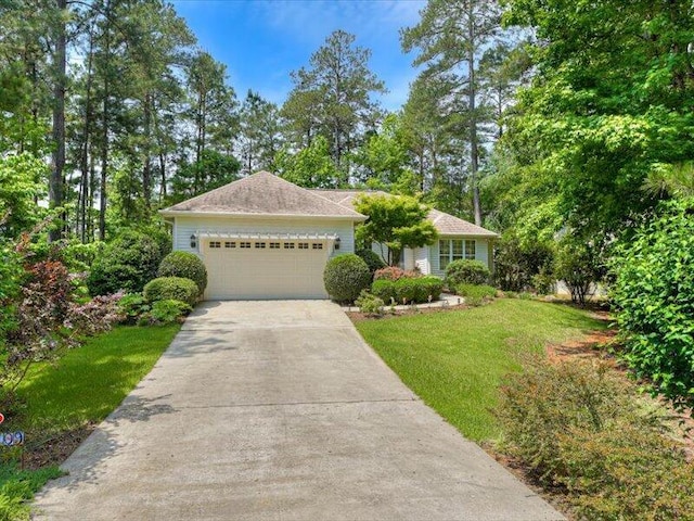 view of front facade with a garage and a front lawn