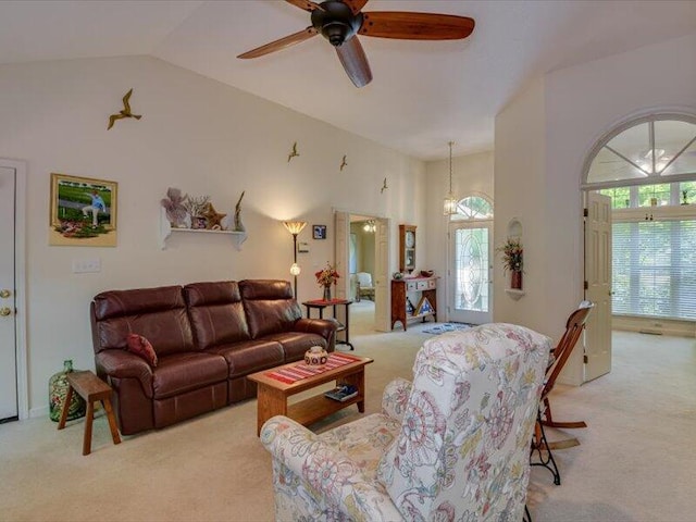 carpeted living room featuring vaulted ceiling and ceiling fan