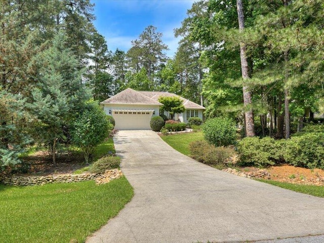 view of front of house featuring a garage and a front lawn