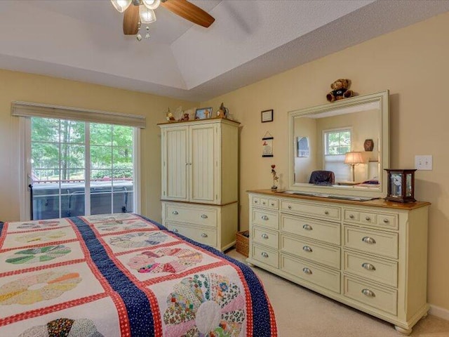 carpeted bedroom with ceiling fan, access to exterior, and lofted ceiling