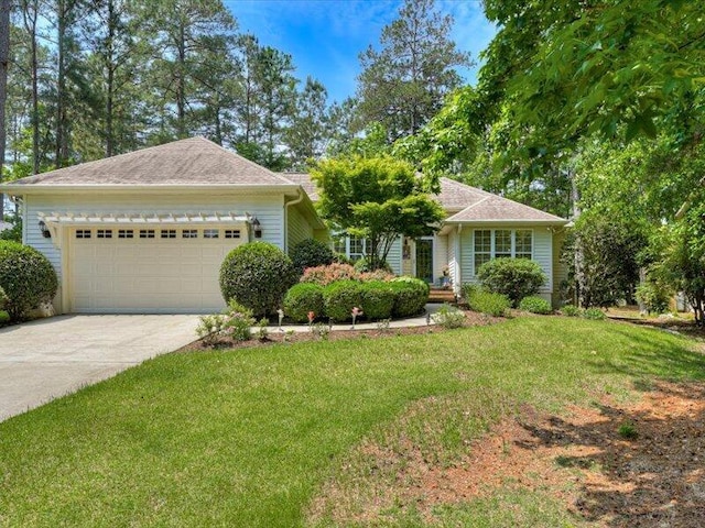 single story home featuring a front yard and a garage