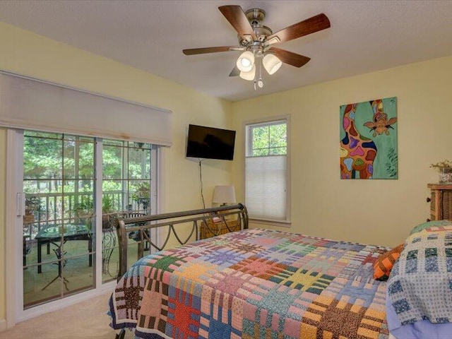 bedroom featuring access to outside, ceiling fan, and light colored carpet