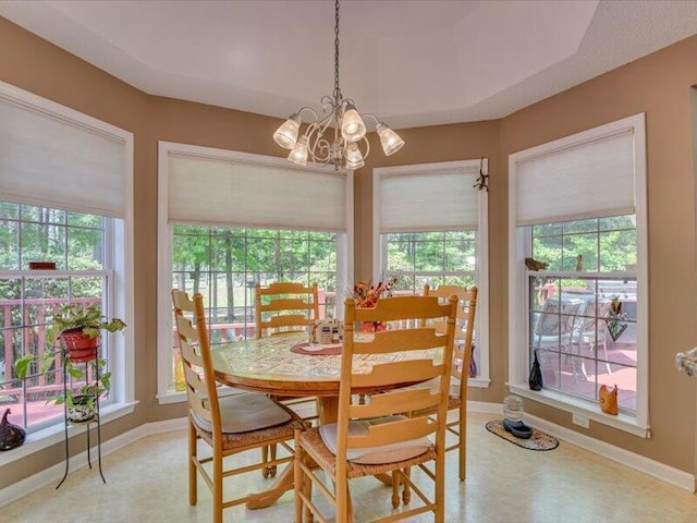 dining area with a healthy amount of sunlight and a chandelier